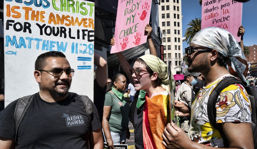 Abortion-rights activists confront an anti-abortion protester at a pro-choice rally on Hollywood Boulevard in Los Angeles, Saturday, July 9, 2022. (AP Photo/Richard Vogel) ** FILE **