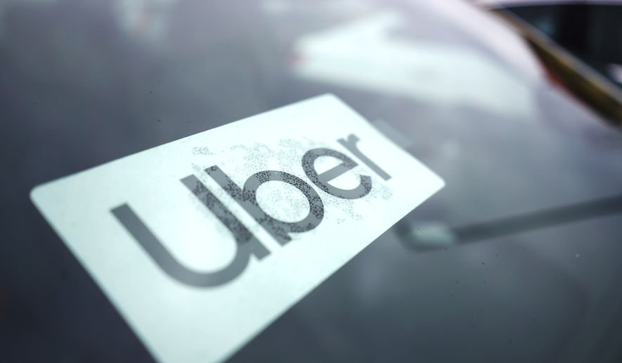 An Uber sign is displayed inside a car in Palatine, Ill., Thursday, Feb. 10, 2022. (AP Photo/Nam Y. Huh) **FILE**