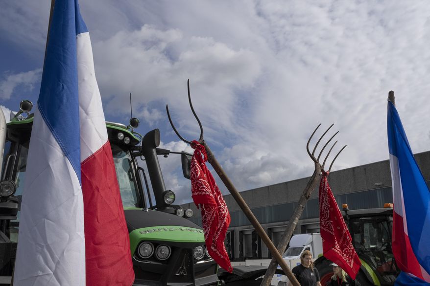 Some 25 tractors were used to blockade a distribution center for supermarket chain Albert Heijn in the town of Zaandam, just north of Amsterdam, Monday, July 4, 2022. Dutch farmers angry at government plans to slash emissions used tractors and trucks Monday to blockade supermarket distribution centers, the latest actions in a summer of discontent in the country's lucrative agricultural sector. (AP Photo/Peter Dejong, File)
