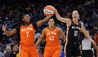 Team Stewart&#39;s Ariel Atkins, left, and Team Wilson&#39;s Sue Bird battle for a loose ball during the first half of a WNBA All-Star basketball game in Chicago, Sunday, July 10, 2022. (AP Photo/Nam Y. Huh)