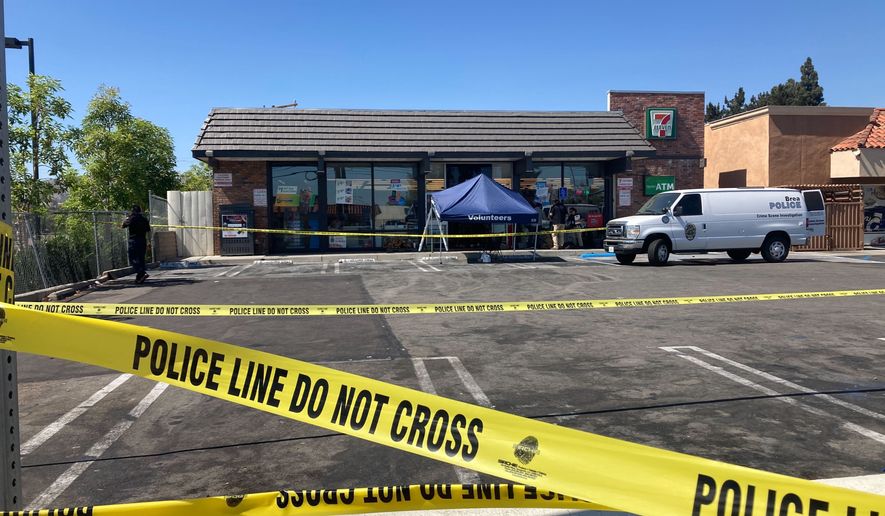 Police crime scene tape closes off a parking area following a shooting at a 7-Eleven store in Brea, Calif., on Monday, July 11, 2022. Police say two people have been killed and three have been wounded in pre-dawn shootings at four Southern California 7-Eleven stores. Authorities said Monday that at least three of the four shootings are believed to be linked to the same lone gunman. (AP Photo/Eugene Garcia)