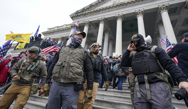 Members of the Oath Keepers on the East Front of the U.S. Capitol on Jan. 6, 2021, in Washington. An upcoming hearing of the U.S. House Committee probing the Jan. 6 insurrection is expected to examine ties between people in former President Donald Trump&#x27;s orbit and extremist groups who played a role in the Capitol riot. (AP Photo/Manuel Balce Ceneta, File)