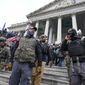 Members of the Oath Keepers on the East Front of the U.S. Capitol on Jan. 6, 2021, in Washington. An upcoming hearing of the U.S. House Committee probing the Jan. 6 insurrection is expected to examine ties between people in former President Donald Trump&#39;s orbit and extremist groups who played a role in the Capitol riot. (AP Photo/Manuel Balce Ceneta, File)