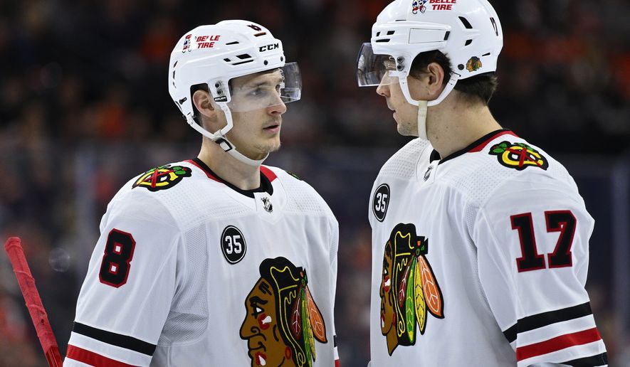 FILE - Chicago Blackhawks&#x27; Dominik Kubalik, left, talks to Dylan Strome during an NHL hockey game against the Philadelphia Flyers, March 5, 2022, in Philadelphia. The Blackhawks continued to dismantle their roster by letting two more players walk. They declined to issue qualifying offers to forwards Kubalik and Strome. (AP Photo/Derik Hamilton, File)