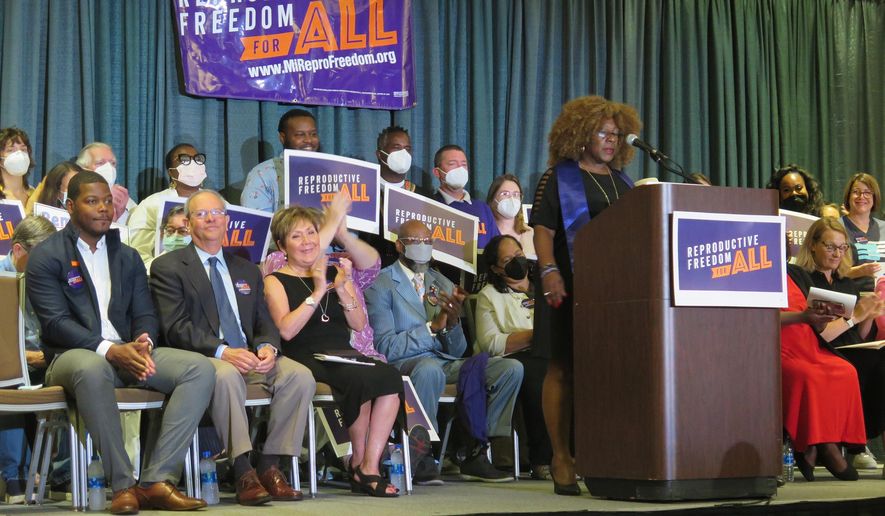 Elder Leslie Mathews, an organizer with Michigan United joins Leaders of the Reproductive Freedom for All campaign as they speak to supporters on Monday, July 11, 2022, in Lansing Mich., after turning in 753,759 signatures to qualify for Michigan's November ballot. (AP Photo/Joey Cappelletti)