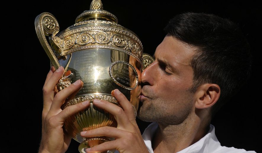 Serbia&#x27;s Novak Djokovic kisses the trophy as he celebrates after beating Australia&#x27;s Nick Kyrgios to win the final of the men&#x27;s singles on day fourteen of the Wimbledon tennis championships in London, Sunday, July 10, 2022. (AP Photo/Kirsty Wigglesworth) **FILE**