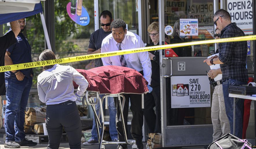 Authorities remove a body from a 7-Eleven after a clerk was fatally shot on Monday, July 11, 2022, during a robbery in Brea, Calif. (Mindy Schauer/The Orange County Register via AP)