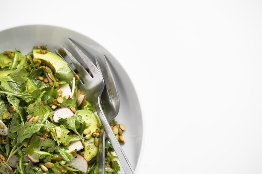 This image released by Milk Street shows a recipe for Arugula and Avocado Salad with Jalapeño Vinaigrette. (Milk Street via AP)