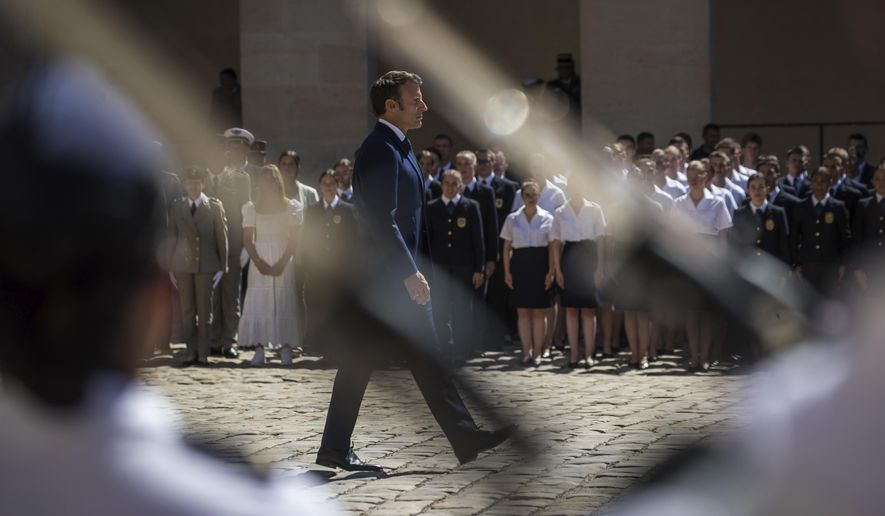 French President Emmanuel Macron attends a military ceremony at the Invalides monument in Paris, Monday, July 11 2022. The military ceremony is held to honor soldiers of the French Armed Forces. (Christophe Petit Tesson, Pool via AP)