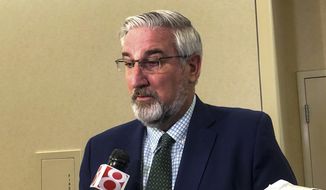 Indiana Gov. Eric Holcomb speaks with reporters after an Indiana Black Expo event at the Indiana Convention Center in Indianapolis, Tuesday, July 12, 2022. (AP Photo/Tom Davies) ** FILE **