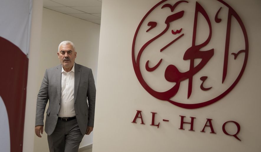 FILE - Shawan Jabarin, director of the al-Haq human rights group, at the organization's offices in the West Bank city of Ramallah, Oct. 23, 2021. Nine European countries said Tuesday, July 12, 2022 that they have seen "no substantial evidence" to support Israel's allegations that six Palestinian civil society groups are terrorist organizations and would not change their policies on supporting the groups. (AP Photo/Majdi Mohammed, File)