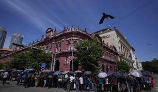 People queue up to enter the official residence of president Gotabaya Rajapaksa three days after it was stormed by anti government protesters in Colombo, Sri Lanka, Tuesday, July 12, 2022. Rajapaksa had vacated the building before the protesters came in. (AP Photo/Eranga Jayawardena)