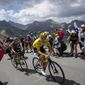 Stage winner and new overall leader Denmark&#39;s Jonas Vingegaard, left, and Slovenia&#39;s Tadej Pogacar, wearing the overall leader&#39;s yellow jersey, climb during the eleventh stage of the Tour de France cycling race over 152 kilometers (94.4 miles) with start in Albertville and finish in Col du Granon Serre Chevalier, France, Wednesday, July 13, 2022. (AP Photo/Thibault Camus)