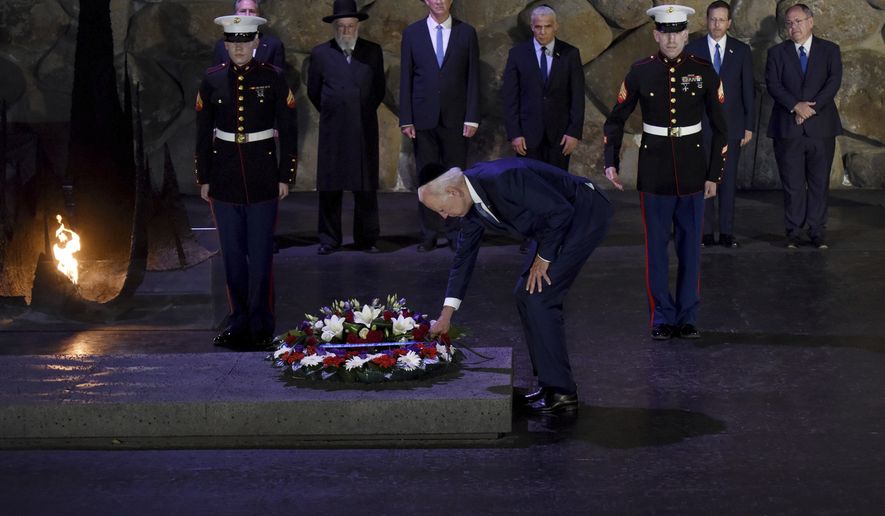 President Joe Biden participates in a wreath laying ceremony at the Hall of Remembrance of the Yad Vashem Holocaust Memorial Museum in Jerusalem, Wednesday, July 13, 2022. (Debbie Hill/Pool via AP)