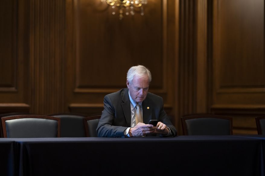 Sen. Ron Johnson, R-Wis., waits for a meeting with other lawmakers, at the Capitol in Washington, Wednesday, June 15, 2022. Evidence revealed at the House select committee investigating the Jan. 6, 2021, insurrection shows that an aide for Sen. Johnson told former Vice President Mike Pence's staff that the Republican from Wisconsin wanted to hand-deliver fake elector votes from Wisconsin and Michigan. (AP Photo/J. Scott Applewhite)