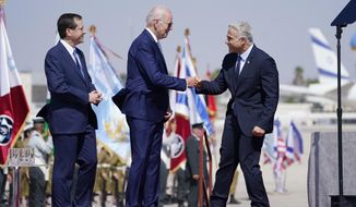 President Joe Biden is greeted by Israeli Prime Minister Yair Lapid, right and President Isaac Herzog, left, as they participate in an arrival ceremony after Biden arrived at Ben Gurion Airport, Wednesday, July 13, 2022, in Tel Aviv. (AP Photo/Evan Vucci)
