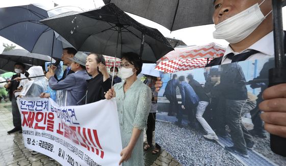 Members of North Korean human rights stage a rally to denounce South Korea&#39;s deportation of two North Korean fishermen in 2019, in front of the National Assembly in Seoul, South Korea, Wednesday, July 13, 2022. South Korean prosecutors raided the country’s main spy agency Wednesday as part of investigations into two past North Korea-related incidents that drew criticism that the previous liberal government ignored basic principles of human rights to improve ties with Pyongyang. (Lim Hun-jung/Yonhap via AP)