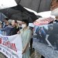 Members of North Korean human rights stage a rally to denounce South Korea&#39;s deportation of two North Korean fishermen in 2019, in front of the National Assembly in Seoul, South Korea, Wednesday, July 13, 2022. South Korean prosecutors raided the country’s main spy agency Wednesday as part of investigations into two past North Korea-related incidents that drew criticism that the previous liberal government ignored basic principles of human rights to improve ties with Pyongyang. (Lim Hun-jung/Yonhap via AP)