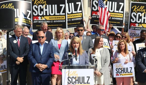 Kelly Schulz, who is seeking the Republican nomination for governor of Maryland, speaks at a news conference on June 30, 2022, in Annapolis, Md., where she criticized a television ad paid for by the Democratic Governors Association. Approaching the final months of his second term, Republican Gov. Larry Hogan, seen left, is encouraging GOP voters to rally behind gubernatorial candidate Kelly Schulz, who served as labor secretary and commerce secretary in his administration. (AP Photo/Brian Witte)
