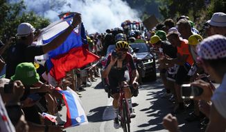 Stage winner Britain&#39;s Thomas Pidcock climbs Alpe D&#39;Huez during the twelfth stage of the Tour de France cycling race over 165.5 kilometers (102.8 miles) with start in Briancon and finish in Alpe d&#39;Huez, France, Thursday, July 14, 2022. (AP Photo/Daniel Cole)