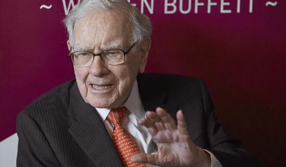 FILE - In this May 5, 2019, file photo, Warren Buffett, Chairman and CEO of Berkshire Hathaway, speaks during a game of bridge following the annual Berkshire Hathaway shareholders meeting in Omaha, Neb. Buffett&#39;s Berkshire Hathaway now controls nearly 20% of Occidental Petroleum&#39;s stock after picking up another $250 million worth of shares of the oil producer this week. Buffett has been buying stocks aggressively this year as the market fell, including investing more than $51 billion in the first quarter alone. (AP Photo/Nati Harnik, File)
