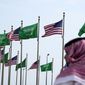 A man stands under American and Saudi Arabian flags prior to a visit by U. S. President Joe Biden, at a square in Jeddah, Saudi Arabia, Thursday, July 14, 2022. As President Joe Biden prepares to meet Saudi Crown Prince Mohammed bin Salman on Friday, the prince&#39;s reputation as a brazen leader whose rise to power coincided with a sweeping crackdown on critics will likely cast a shadow on the meeting. (AP Photo/Amr Nabil, File)