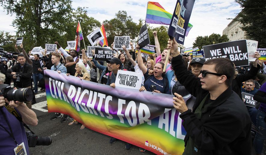 In this Oct. 8, 2019, photo, supporters of LGBTQ rights stage a protest on the street in front of the U.S. Supreme Court in Washington. A judge in Tennessee on Friday, July 15, 2022, has temporarily barred two federal agencies from enforcing directives issued by President Joe Biden&#39;s administration that extended protections for LGBTQ people in schools and workplaces. (AP Photo/Manuel Balce Ceneta, File)