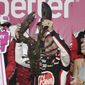 Christopher Bell holds up a giant lobster while celebrating with his wife, Morgan, right, after winning a NASCAR Cup Series auto race at the New Hampshire Motor Speedway, Sunday, July 17, 2022, in Loudon, N.H. (AP Photo/Charles Krupa) **FILE**