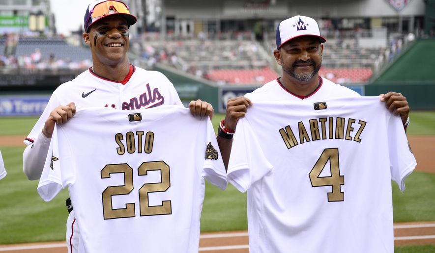 Washington Nationals right fielder Juan Soto (22) and manager Dave Martinez (4) pose with their All-Star jerseys before a baseball game against the Atlanta Braves, Sunday, July 17, 2022, in Washington. (AP Photo/Nick Wass)