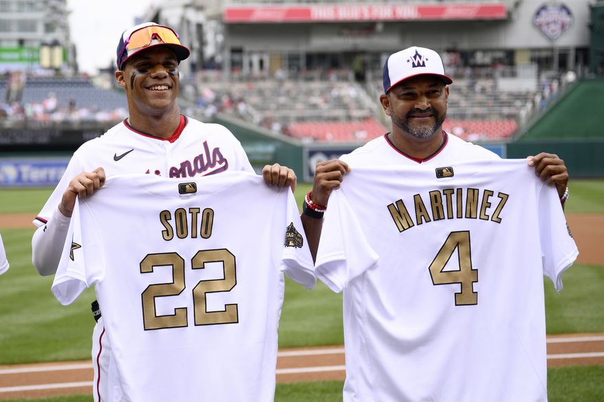 Washington Nationals right fielder Juan Soto (22) and manager Dave Martinez (4) pose with their All-Star jerseys before a baseball game against the Atlanta Braves, Sunday, July 17, 2022, in Washington. (AP Photo/Nick Wass)