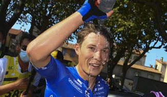 Stage winner Belgium&#39;s Jasper Philipsen poured water over his head after the fifteenth stage of the Tour de France cycling race over 202.5 kilometers (125.5 miles) with start in Rodez and finish in Carcassonne, France, Sunday, July 17, 2022. (Tim De Waele/Pool Photo via AP)