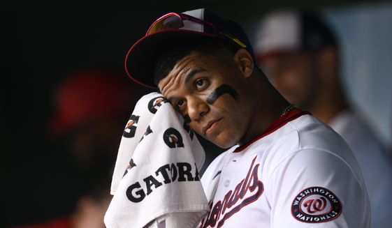 Washington Nationals&#39; Juan Soto wipes his face in the dugout before a baseball game against the Atlanta Braves, Sunday, July 17, 2022, in Washington. (AP Photo/Nick Wass)