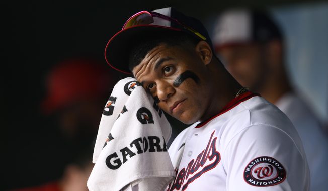 Washington Nationals&#x27; Juan Soto wipes his face in the dugout before a baseball game against the Atlanta Braves, Sunday, July 17, 2022, in Washington. (AP Photo/Nick Wass)