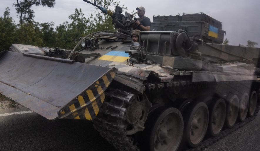 Ukrainian soldiers ride a tank on a road, in Stupochky, Donetsk region, eastern Ukraine, Sunday, July 10, 2022.  Ukrainians living in the path of Russia&#x27;s invasion in the besieged eastern Donetsk region are bracing themselves for the possibility that they will have to evacuate. (AP Photo/Nariman El-Mofty, File)
