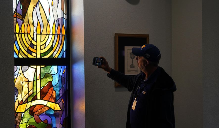 A stained glass window that once had bullet holes is now repaired at Congregation Beth Israel in Colleyville, Texas, Thursday, April 7, 2022. In January, four were taken hostage by a pistol-wielding man during a Shabbat service. (AP Photo/LM Otero, File)