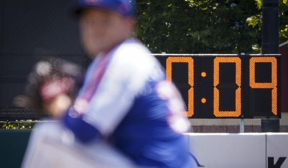 A pitch clock is deployed to restrict pitcher preparation times during a minor league baseball game between the Brooklyn Cyclones and Greensboro Grasshoppers, Wednesday, July 13, 2022, in the Coney Island neighborhood of the Brooklyn borough of New York. Major League Baseball is considering a pitch clock for next year along with shift limits, larger bases and restrictions on pickoff attempts.  (AP Photo/John Minchillo) **FILE**