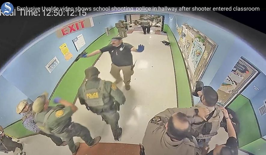 In this photo from surveillance video provided by the Uvalde Consolidated Independent School District via the Austin American-Statesman, authorities respond to the shooting at Robb Elementary School in Uvalde, Texas, on May 24, 2022. Nearly 400 law enforcement officials rushed to the mass shooting that left 21 people dead at the elementary school but “systemic failures” created a chaotic scene that lasted more than an hour before the gunman was finally confronted and killed, according to a report from investigators released Sunday, July 17, 2022. (Uvalde Consolidated Independent School District/Austin American-Statesman via AP, File)