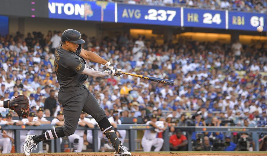 American League&#x27;s Giancarlo Stanton, of the New York Yankees, swings at a pitch while hitting a two-run home run off National League pitcher Tony Gonsolin, of the Los Angeles Dodgers, during the fourth inning of the MLB All-Star baseball game, Tuesday, July 19, 2022, in Los Angeles. (AP Photo/Mark J. Terrill)