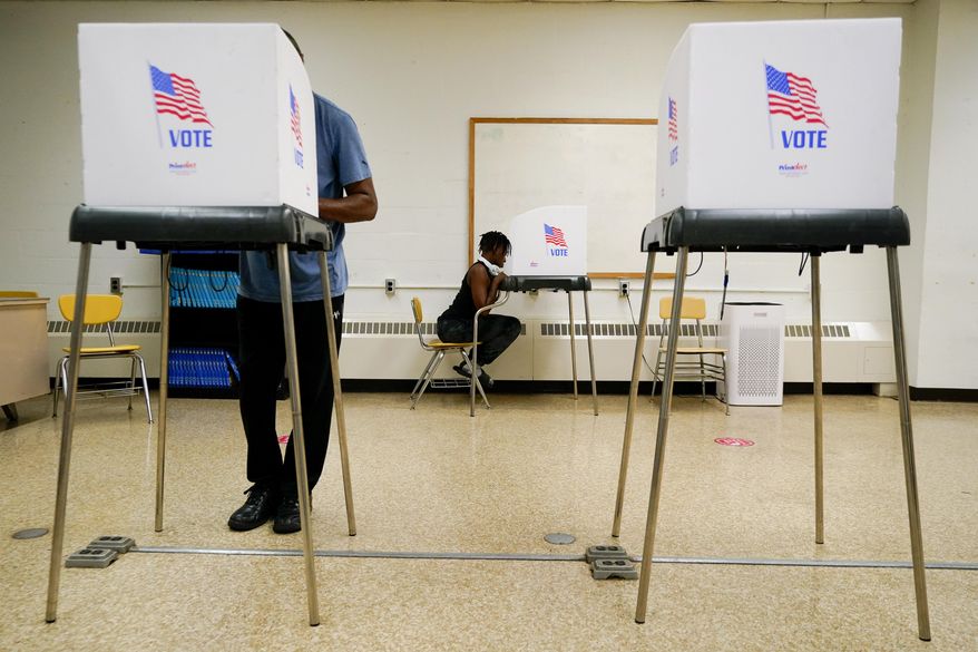 People cast votes at Edmondson Westside High School during Maryland's primary election, Tuesday, July 19, 2022, in Baltimore. (AP Photo/Julio Cortez)