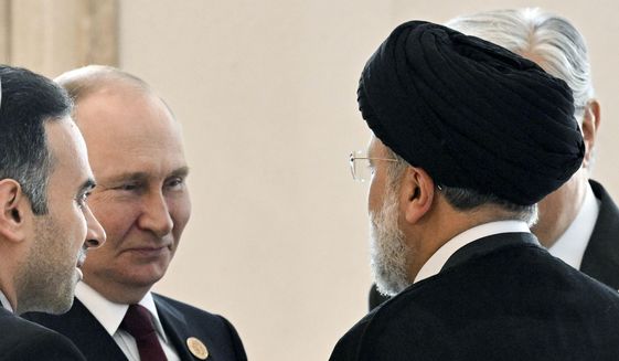 Russian President Vladimir Putin, left, speaks to Iran&#39;s President Ebrahim Raisi, back to a camera, on the sideline of the summit of Caspian Sea littoral states in Ashgabat, Turkmenistan, on June 29, 2022. Putin&#39;s visit to Iran starting Tuesday, July 19, is intended to deepen ties with regional heavyweights as part of Moscow&#39;s challenge to the United States and Europe amid its grinding campaign in Ukraine. (Grigory Sysoyev, Sputnik, Kremlin Pool Photo via AP, File)
