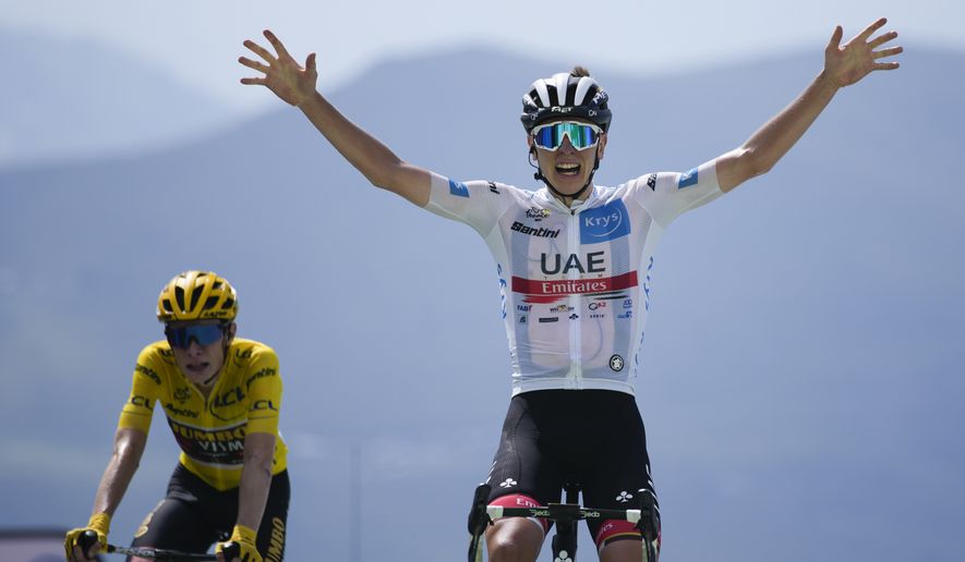 Stage winner Slovenia&#39;s Tadej Pogacar, wearing the best young rider&#39;s white jersey, celebrates as he crosses the finish line ahead of Denmark&#39;s Jonas Vingegaard, wearing the overall leader&#39;s yellow jersey, during the seventeenth stage of the Tour de France cycling race over 130 kilometers (80.8 miles) with start in Saint-Gaudens and finish in Peyragudes, France, Wednesday, July 20, 2022. (AP Photo/Daniel Cole)
