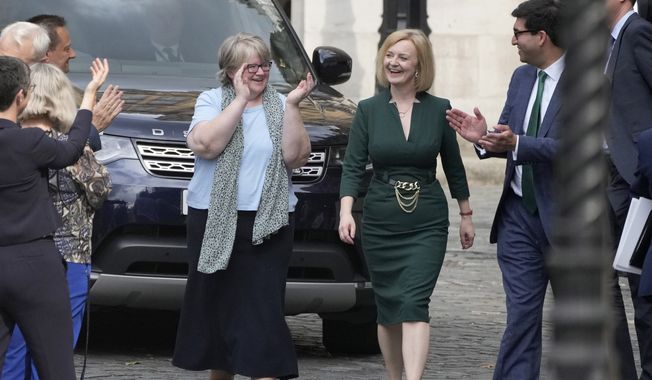 Britain&#x27;s Secretary of State for Foreign, Commonwealth and Development Affairs Liz Truss receives applause from her team near Parliament in London, Wednesday, July 20, 2022. Britain’s Conservative Party has chosen Rishi Sunak and Liz Truss as the two finalists in an election to replace Prime Minister Boris Johnson. The pair came first and second in a vote of Conservative lawmakers on Wednesday. (AP Photo/Frank Augstein)