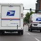 A USPS logo adorns the back doors of United States Postal Service delivery vehicles as they proceed westbound along 20th Street from Stout Street and the main post office in downtown Denver, Wednesday, June 1, 2022. USPS plans to substantially increase the number of electric-powered vehicles it’s buying to replace its fleet of aging delivery trucks, officials said Wednesday, July 20, 2022. (AP Photo/David Zalubowski, File)