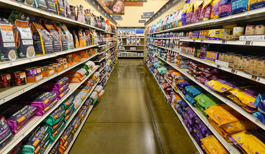 Dog food is shown in a pet store in Westfield, Ind., Tuesday, July 19, 2022. In 2018, the FDA began investigating whether the increasing popularity of grain-free dog foods had led to a sudden rise in a potentially fatal heart disease in dogs. Four years later, the FDA has reached no conclusion, but the publicity surrounding the issue has shrunk the once-promising market for grain-free dog foods. (AP Photo/Michael Conroy)