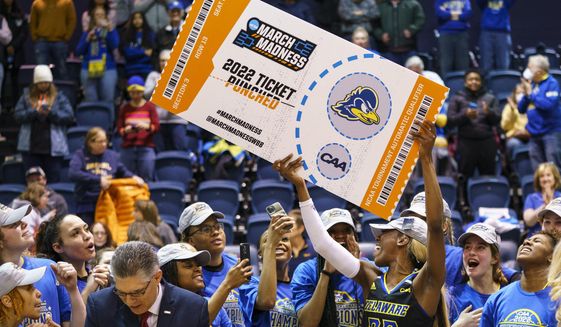 Delaware&#39;s Jasmine Dickey holds up the March Madness ticket following the second half of an NCAA college basketball championship game against Drexel in the Colonial Athletic Association Conference Tournament, Sunday, March 13, 2022, in Philadelphia. Delaware won 63-59. The NCAA has adequately addressed nine of 23 recommendations for creating comparable NCAA Tournament experiences for men&#39;s and women&#39;s basketball players, according to a progress report released Wednesday. July 20, 2022. (AP Photo/Chris Szagola, File) **FILE**