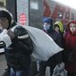 People from Mariupol and eastern Ukraine disembark from a train at the railway station in Nizhny Novgorod, Russia, Thursday, April 7, 2022, to be taken to temporary residences in the region. About 500 refugees from the Mariupol area arrived in Nizhny Novgorod on a special train organized by Russia from eastern Ukraine, about 500 miles (800 kilometers) from the border. (AP Photo)