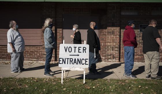 In this Nov. 3, 2020, file photo, voters wait in line outside a polling center on Election Day, in Kenosha, Wis. (AP Photo/Wong Maye-E, File)