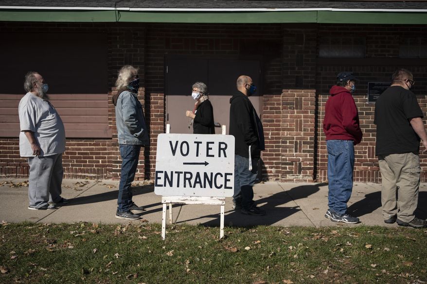 In this Nov. 3, 2020, file photo, voters wait in line outside a polling center on Election Day, in Kenosha, Wis. (AP Photo/Wong Maye-E, File)