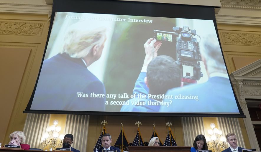As Eric Herschmann, former White House adviser, speaks on a video, a photo of President Donald Trump in the Rose Garden recording a video on Jan. 6 is displayed, as the House select committee investigating the Jan. 6 attack on the U.S. Capitol holds a hearing at the Capitol in Washington, Thursday, July 21, 2022. (AP Photo/Patrick Semansky)