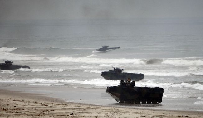 Amphibious Assault Vehicles storm Red Beach during exercises at Camp Pendleton, Calif., June 2, 2010. The U.S. Marine Corps will keep its new amphibious combat vehicle - a kind of seafaring tank - out of the water while it investigates why two of the vehicles ran into troubles off the Southern California coast this week amid high surf, military officials said Wednesday, July 20, 2022. (AP Photo/Lenny Ignelzi, File)